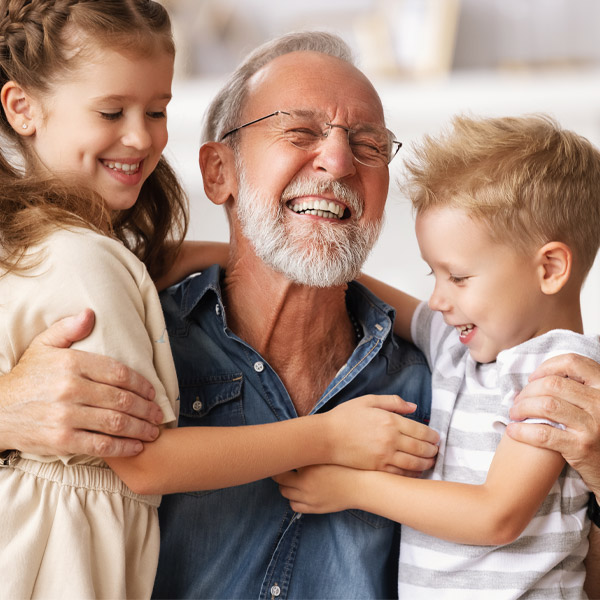 grandpa hugging his grandchildren