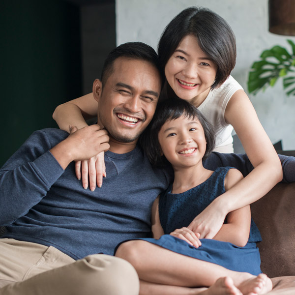 family of three smiling together